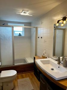 a bathroom with a toilet and a sink and a tub at Lerchenhaus in Bliestorf +4 photos