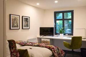 a bedroom with a bed and a desk with a computer at IDEENRAUM in Osnabrück +22 photos