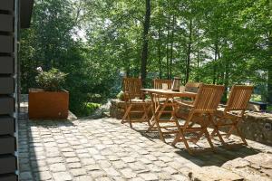 a wooden table and chairs on a stone patio at IDEENRAUM in Osnabrück