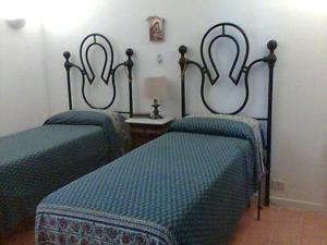 Letto o letti in una camera di La Cisterna, not only landscape