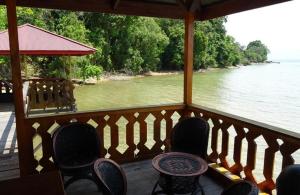 a porch with chairs and a view of the water at Dolidi Ndano Towale Resort in Peura