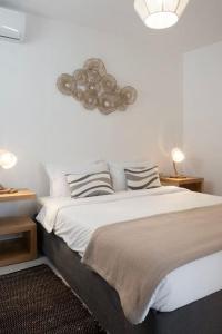 a bedroom with a large bed with two pillows at Ornos Vibes 1 in Mikonos