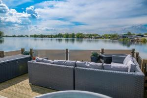 a deck with a view of a large body of water at Lake View with Private Hot Tub at Tattershall Lakes in Tattershall