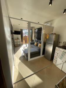 een woonkamer met een bank en een koelkast bij Beautiful & Secured yellow House for 2 - Center of Osu in Accra