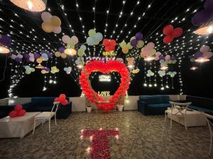 a room with a heart balloon display and a teddy bear at The Nines hotel & restro in Kālādhūngi
