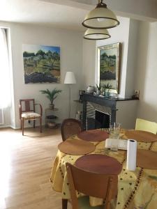 a living room with two tables and a fireplace at Maison au cœur de la cité in Foix +11 photos