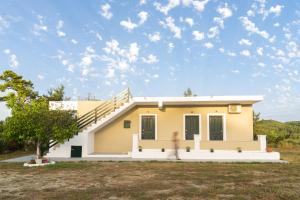 a woman walks in front of a house at ELPIS appartment in Vitalades