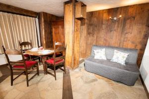 a living room with a table and a couch at Maison Justy in Cogne