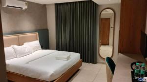 um quarto de hotel com uma cama e um espelho em Livi Suites - Premium 1 BHK Serviced Apartments em Bangalore