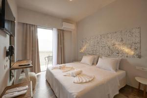 Кровать или кровати в номере CICADA HOTEL
