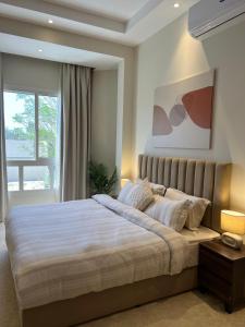 a bedroom with a large bed and a window at Halima Shared Housing - Female only in Dubai