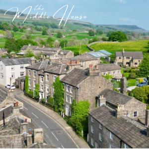 a small village with houses and a road at Middle House in Askrigg