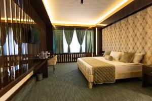 a bedroom with a bed and a large window at Dashli Qala Hotel in Ganja
