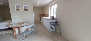 a room with a kitchen and a table and a bed at Studio au pied du château. in Saint-Aignan