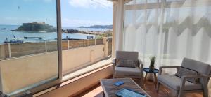Villa en bord de mer face à l'Ile de Porquerolles في هييريس: غرفة مع نافذة كبيرة مطلة على المحيط