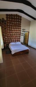 a bedroom with a bed and a brick wall at Hotel campestre santa rita 