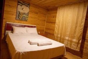 a bedroom with a bed with towels on it at Obelix Bungalows in Fethiye