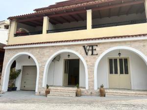 a building with two arches and the word on it at Vasiliki apartments in Lákka