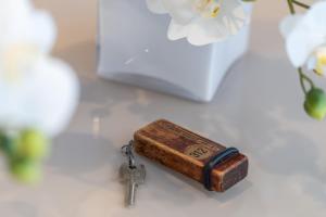 a key sitting on a table next to a vase at HOTEL la SERENISSIMA TERME & SPA in Abano Terme