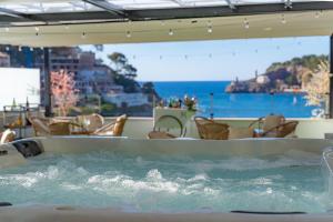a hot tub with a view of the ocean at Hotel Boutique Minister 4Sup in Port de Soller
