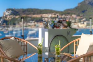 a table with two drinks on top of a balcony at Hotel Boutique Minister 4Sup in Port de Soller