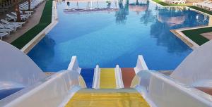 a water slide in a swimming pool at Bodrum Liman Resort in Bodrum City