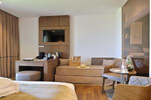 a hotel room with a bed and a living room at Hôtel Le Week end in Ajaccio
