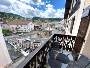a balcony with a view of a city street at Le Carrousel 4-6p Plein centre in Gérardmer