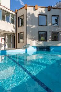 a swimming pool in front of a building at HOTEL la SERENISSIMA TERME & SPA in Abano Terme