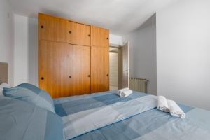 a bedroom with a large bed and a wooden cabinet at Apartment Blu in Poreč