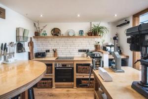 a kitchen with wooden counters and a brick wall at Springhill Studio, Brimham Rocks Yorkshire Dales in Grantley