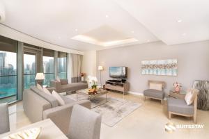 a living room with a couch and a tv at OSTAY -Address Dubai Mall - The Residence in Dubai