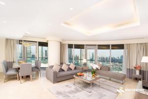 a living room with a couch and a table at OSTAY -Address Dubai Mall - The Residence in Dubai