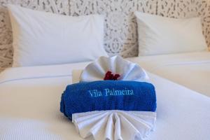 a blue and white towel on a bed at Apartamentos Turisticos Vila Palmeira in Lagos
