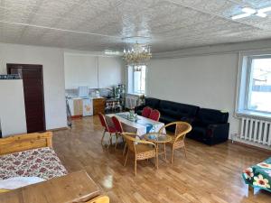 a living room with a couch and a table and chairs at Selenge in Mörön