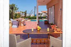 a table with fruit on it on a patio at Villa Armonia Chania in Kato Galatas
