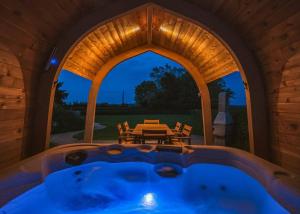 a room with a hot tub in a house at Luckington Burrows in Frome