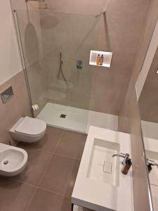 a bathroom with a shower and a toilet and a sink at Al Ventisei - Azzurro in Treiso +6 photos