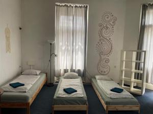 a room with two beds and a window at Hostel Moravia Ostrava in Ostrava