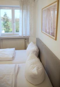 a hotel room with two beds and a couch at Hotel & Gasthof Wagner in Aichach