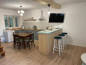 a kitchen with a table and some chairs and a counter at Kisielkowo in Wilkasy