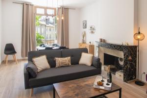 a living room with a couch and a fireplace at T4 Cosy Centre ville Château WIFI in Aubenas +13 photos