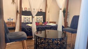 a room with a bed with two chairs and a glass table at Elin Otel Alaçatı in Cesme +68 photos
