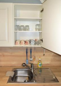 a kitchen sink in a kitchen with a counter top at Wohnung im Schlösschen in Lichtenfels