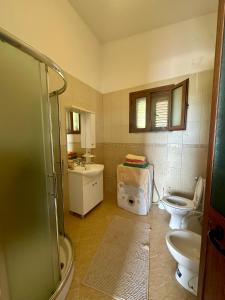 a bathroom with two toilets and a sink at Fabio Apartments Gjiri i Lalzit in Draç