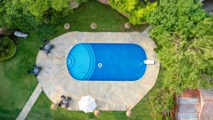 an overhead view of a swimming pool in a yard at Saj By The Lake, Malshej Ghat in Malshej Ghat