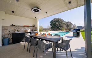 a patio with a table and chairs and a swimming pool at Villa Mia Stella in Štanga