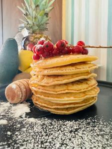 a stack of pancakes with fruit on top of it at Hotel Butterfly Wellness & Spa in Rimini
