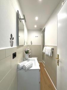 a white bathroom with a sink and a mirror at CINQUE TERRE MONEGLIA in Moneglia