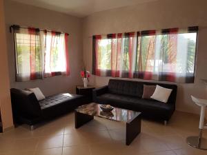 a living room with a couch and a coffee table at Casa Caleton in Río San Juan